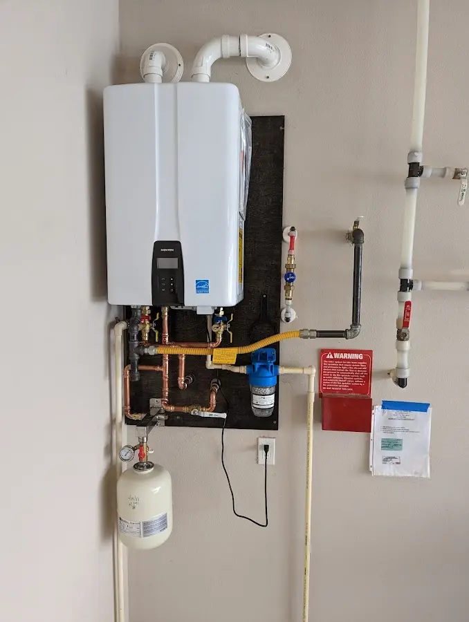 Professional plumber installing copper piping in a Hatfield home